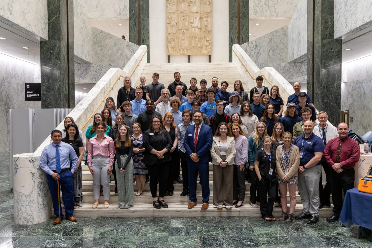 Members of BOCES statewide stand on the marble stairs within the New York State Capitol's Well space