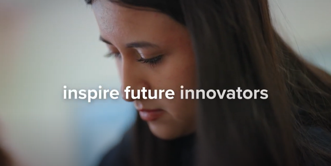 A child looks down at something on her desk with the phrase "inspire future educators" written on top of the image